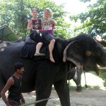 Kelli Barnes and Deborah Burger catching the latest Abu Dhabi news while riding an elephant in Sri Lanka
