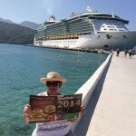 Susan Selby in Haiti with the cruise liner she is travelling on docked in the background