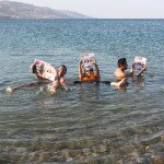 Marvin Delfin, Virgie Aguilar and Eugine Ulep floating in the Dead Sea, Jordan