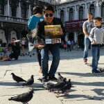 Rhency feeding the birds in San Marco, Venice, Italy.